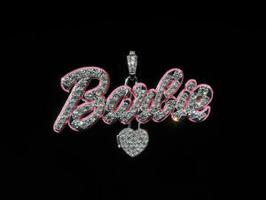 Diamond-encrusted pendant of the word "Barbie" in cursive and a dangling heart charm below the "r."