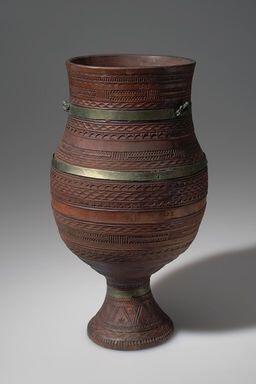 Red-brown Kumiss goblet with pedestal base and horizontal geometric designs and metallic strips