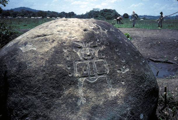 A boulder with a petroglyph depicting a biped with horns.