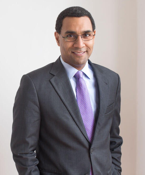 Headshot of Sean M. Decatur wearing glasses and suit. 