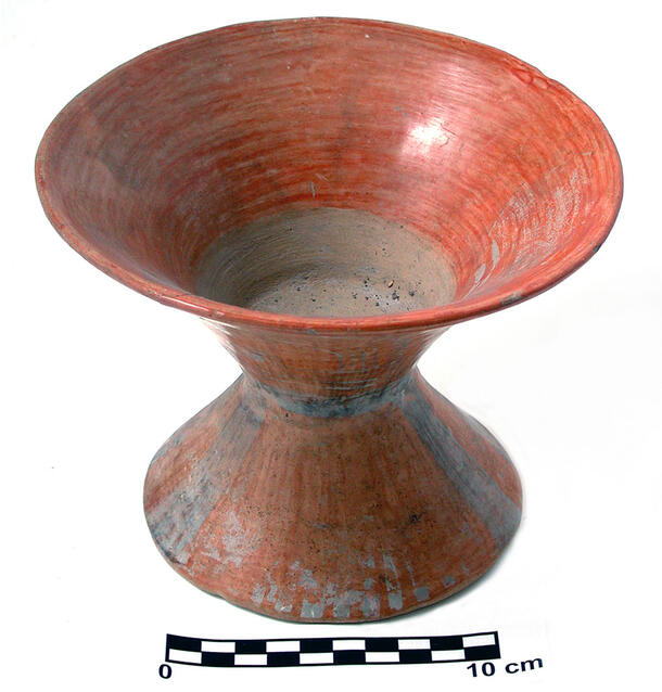 A red-painted ceramic vessel for containing pulque, a fermented drink.