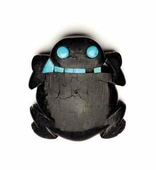 Small ebony carving of a frog with turquoise eyes and inlay.