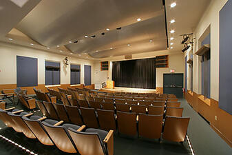 The Linder theater has rows of seating and a large screen and is available for meetings, conferences, and screenings at AMNH.