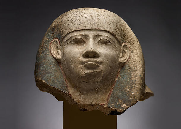 Smoothly sculpted head showing a detailed face, ears and headdress.