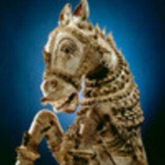 A sculpture of a horse with an ornate headdress.