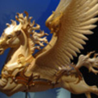 A winged horse made of a gold-colored material.