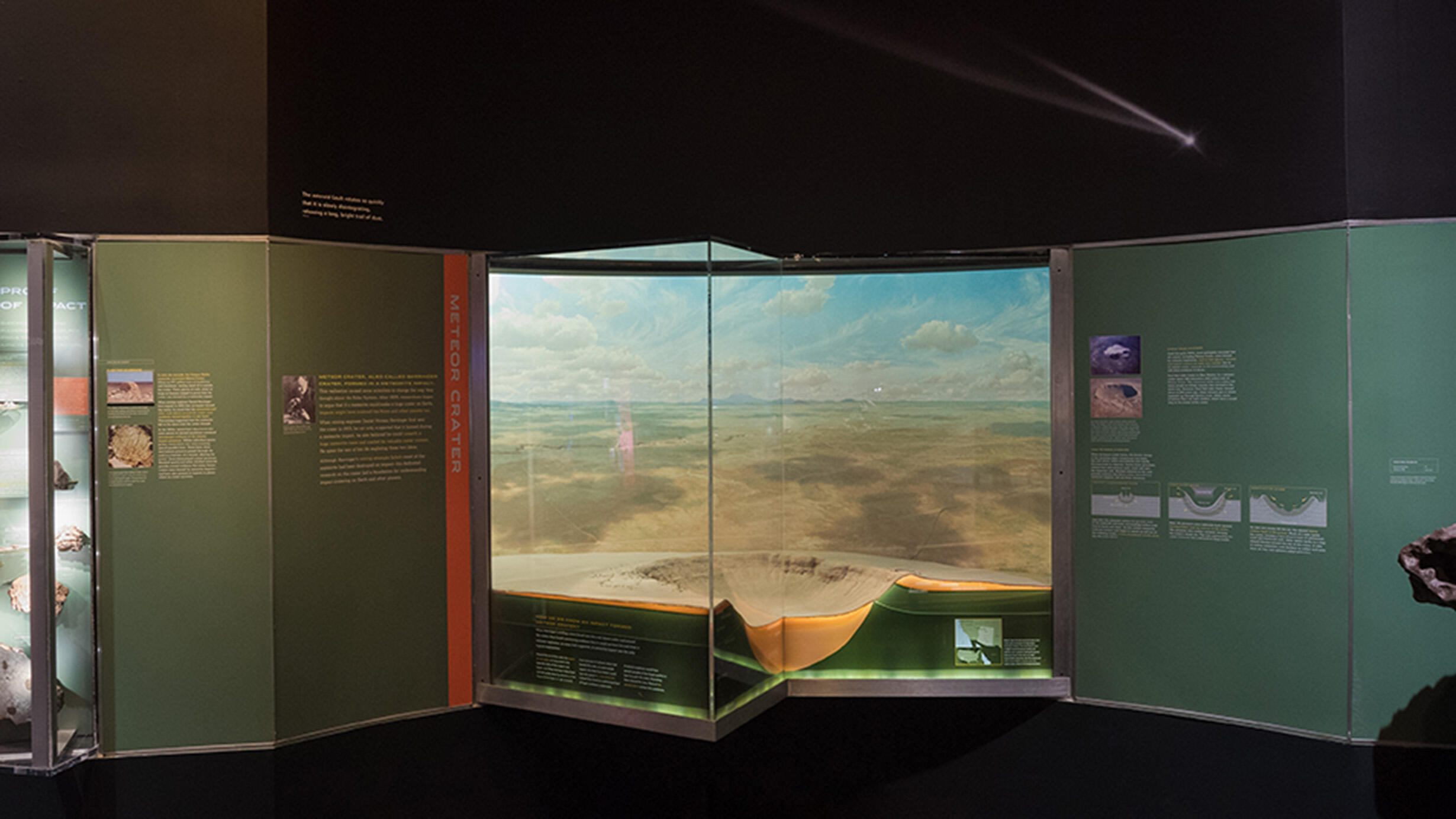 Scale model of Meteor Crater with text and images on its sides