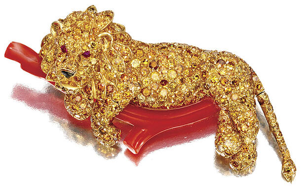 Jeweled lion rests on a coral "branch".