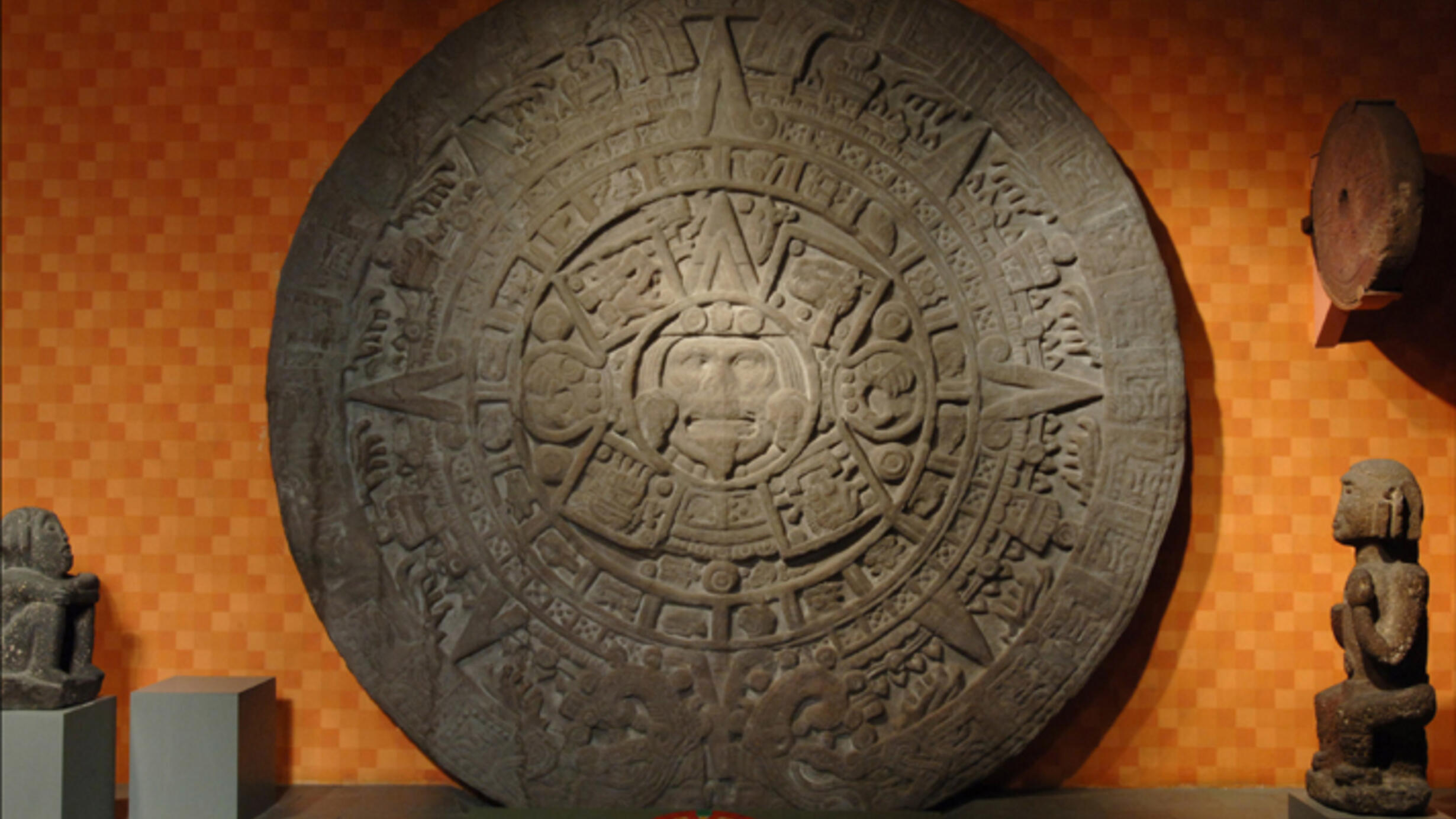 The Aztec Stone of the Sun, a round calendar carved from a single piece of stone and featuring symbols relating to the sun.