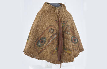 Skirt created from thin cedar strips, decorated with a painted design.