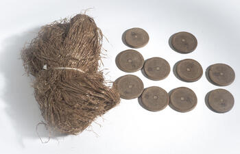 Ten small circular wood pieces, and a wrapped bunch of thin twine.