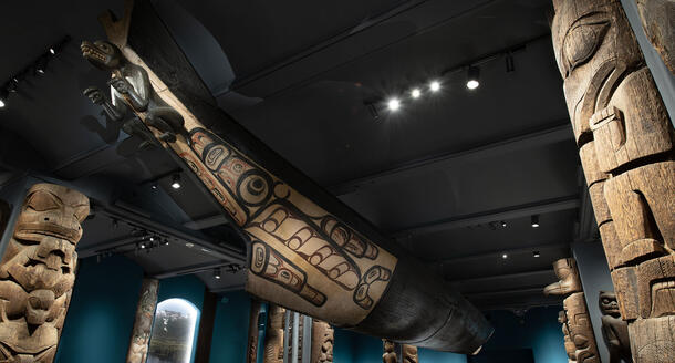 An immense canoe with a prow in the form of a wolf hangs from the ceiling of a Museum hall.