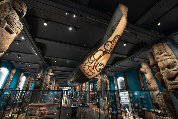 Large wooden, painted canoe hangs from the ceiling in the Museum's Northwest Coast Hall gallery.