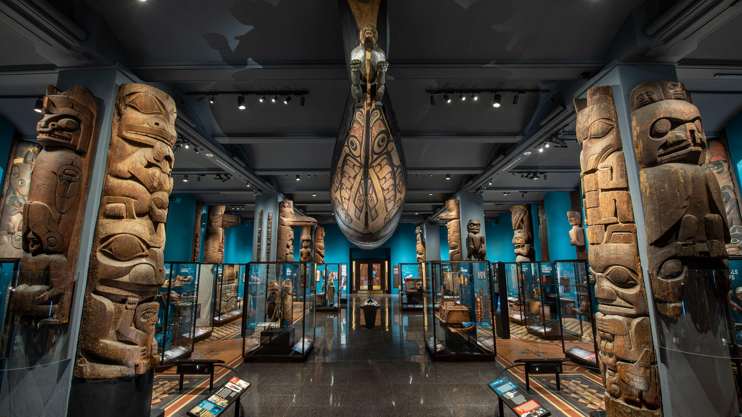 The Great Canoe is suspended from the ceiling, and totem poles and glass display cases line the newly revitalized Northwest Coast Hall.