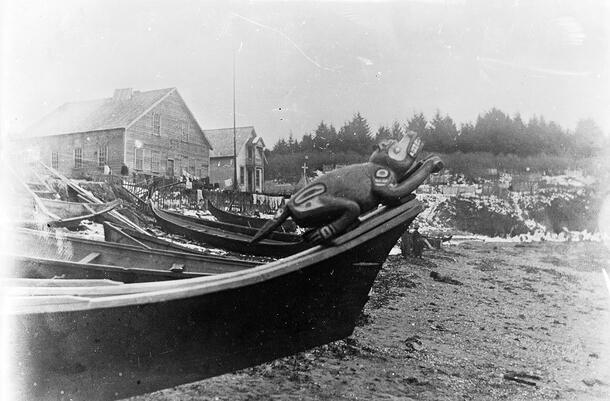 Historical photo of the original beaver prow perched on a boat as it navigates through the harbor.