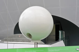 A small white sphere on display in the Museum's Rose Center for Earth and Space.