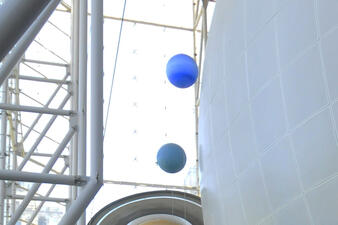 In the Museum’s Rose Center for Earth and Space, models of the planets Neptune and Uranus suspended beside the Hayden Sphere.