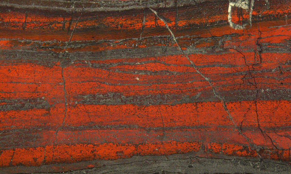 Close-up of bright and dark colored layers from a physical science specimen. 