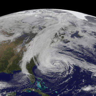 Satellite imagery of swirling white clouds over the east coast of the United States.
