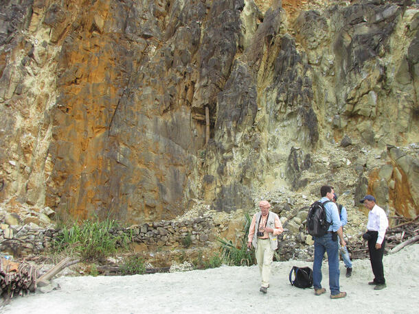 George Harlow, James Webster and two local colleagues standing before a rock face in northern Myanmar.