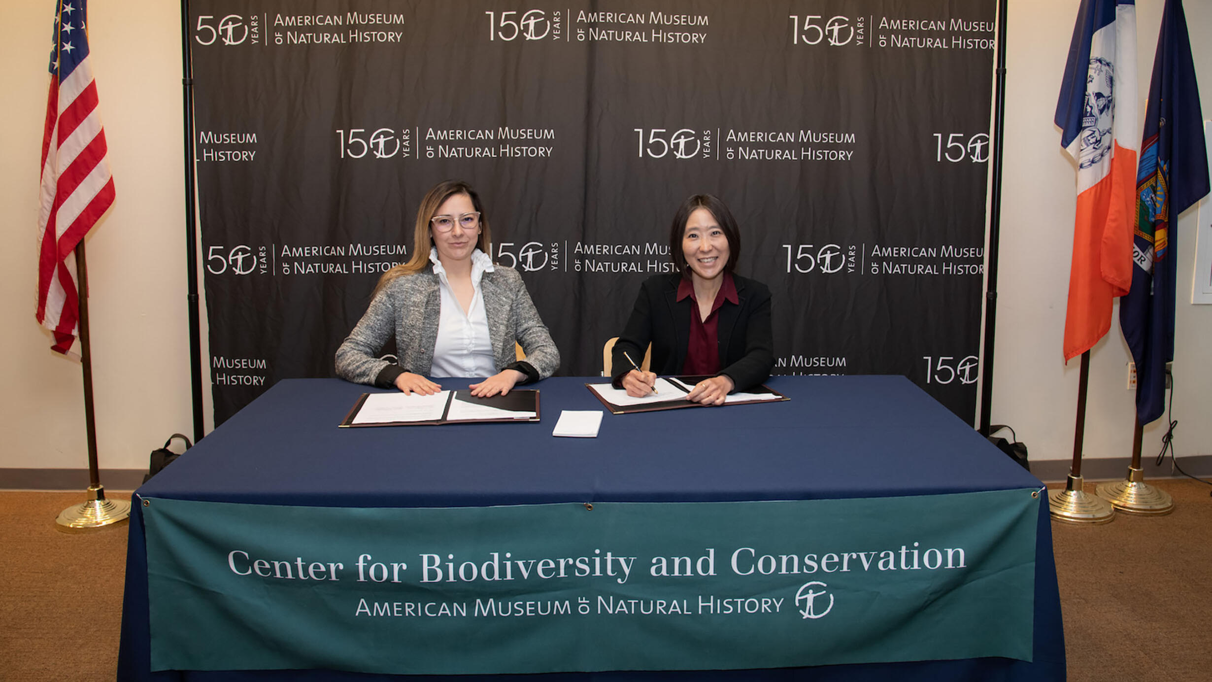 Two people seated at a table with a Center for Biodiversity and Conservation banner.