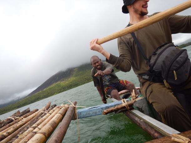 Two men, Brian Smith and local guide Chief Paul, row a canoe across Lake Letes near Gaua Island in Melaniesia.