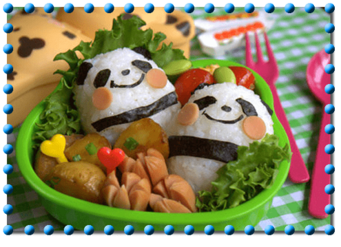 bento box with 2 rice balls decorated to look like pandas