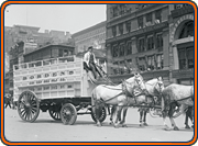 black and white image of horse-drawn streetcar in a city