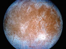 Europa, a moon with brown center and blue perimeter 