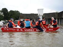 People being resqued by boat by the U.S. coast Guard during a flood in Louisiana