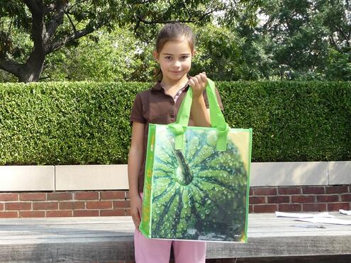 girl holding reusable shopping bag