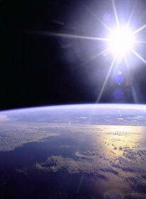 the sun shining with earth at the horizon