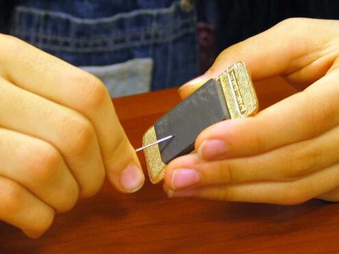 rubbing a needle against a bar magnet