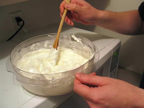 stirring the melted marshmallow and butter mixture
