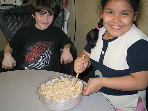 stirring the Rice Krispies into the the marshmallow butter mixture