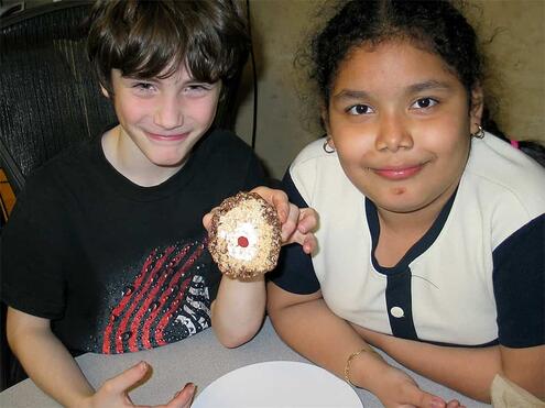 two kids showing off the edible earth that they made