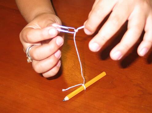 tying the other end of the string to a paper clip