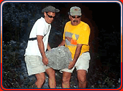 Ed and another scientist hauling a boulder