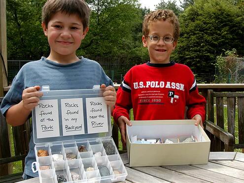 two boys displaying their rock collections