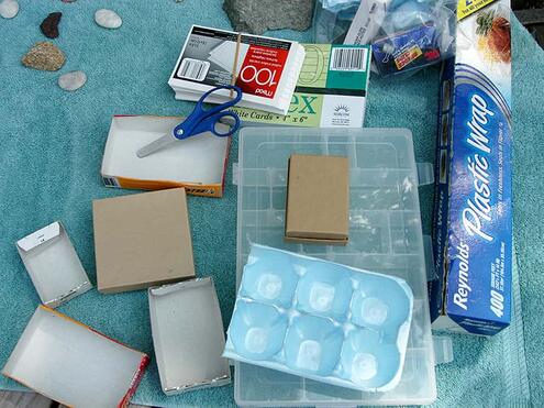 materials needed including a shoe box, scissors, assorted small containers, a plastic tray