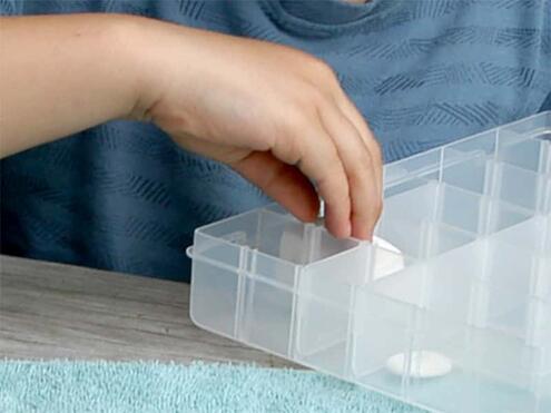 placing rocks into container with clear dividers