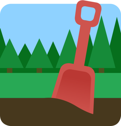A plastic shovel in dark soil, with grass and forest trees in the background.
