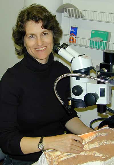 Amy Davidson at a microscope with fossil specimen