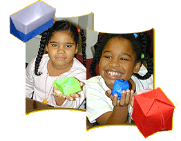 two young girls holding origami boxes
