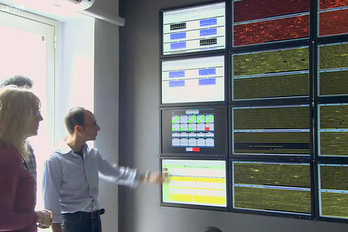 Scientists observe a wall of digital monitors that constantly relay Mt. Etna’s vital signs