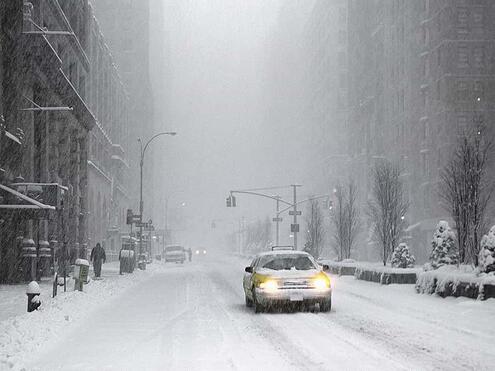 car driving down a snowy city street