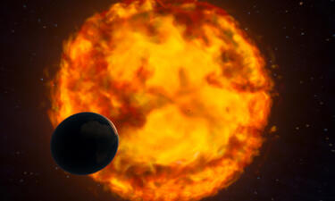 A small planet faces a much larger fiery sun