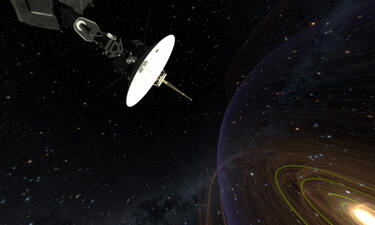 Space probe Voyager is shown in space positioned with a satellite pointing towards the solar system