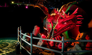 A large model of a European dragon bathed in dramatic red light