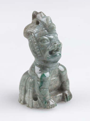 A small, stylized jade figurine of a were-jaguar.